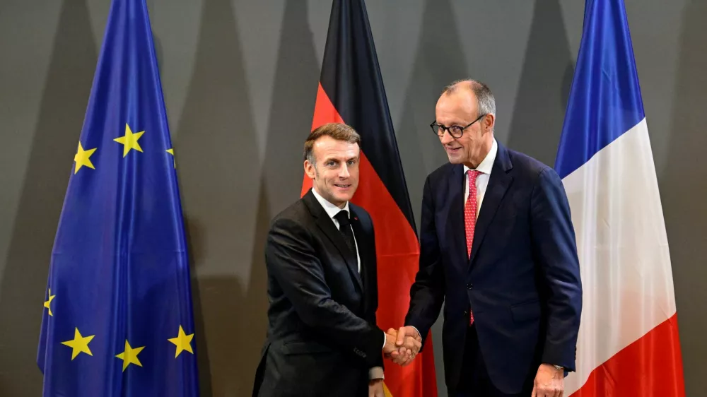 France's President Emmanuel Macron and Germany's Chancellor Friedrich Merz shake hands ahead of a bilateral meeting at the sidelines of a summit on Europe's technological sovereignty, in the EUREF Campus in Berlin, Germany, November 18, 2025.   JOHN MACDOUGALL/Pool via REUTERS