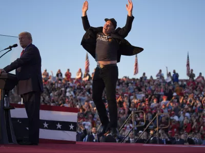 FILE - Elon Musk jumps on the stage as Republican presidential nominee former President Donald Trump speaks at a campaign rally at the Butler Farm Show, Oct. 5, 2024, in Butler, Pa. (AP Photo/Evan Vucci, File)