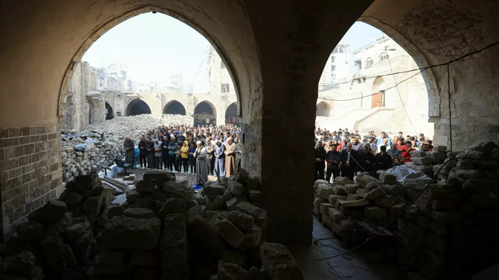 Palestinians perform Friday prayers at the Omari Mosque, which was damaged by Israeli shelling during the war, in Gaza City November 21, 2025. REUTERS/Dawoud Abu Alkas