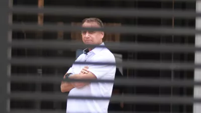 FILE - Brazil's former President Jair Bolsonaro stands at the entrance of his home where he is under house arrest in Brasilia, Brazil, Tuesday, Sept. 2, 2025. (AP Photo/Luis Nova, File)