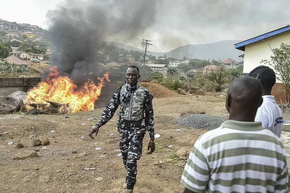Members of the Sierra Leone National Drugs Enforcement Agency look on as they burn narcotics kush, drugs and chemicals in Freetown on April 20, 2024 after the declaration of the national emergency on drug abuse.,Image: 866511219, License: Rights-managed, Restrictions:, Model Release: no