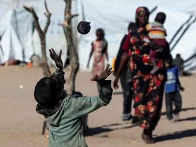 Mousa Bakr, 8, a Sudanese refugee from al-Fashir, plays with a handmade sock ball because they have no access to a real football at the Tine transit refugee camp in eastern Chad, amid the ongoing conflict between the paramilitary Rapid Support Forces (RSF) and the Sudanese army, November 23, 2025. REUTERS/Amr Abdallah Dalsh   TPX IMAGES OF THE DAY