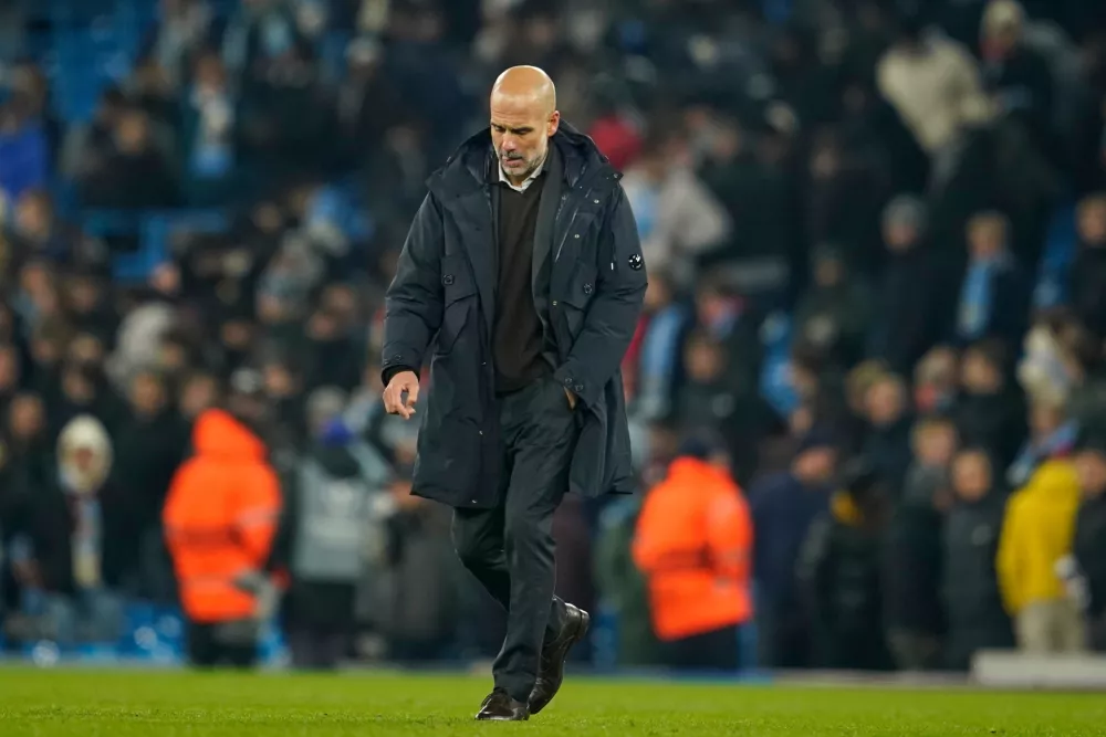 Manchester City's head coach Pep Guardiola walks on the pitch after the end of the Champions League opening phase soccer match between Manchester City and Bayer Leverkusen in Manchester, England, Tuesday, Nov. 25, 2025. (AP Photo/Dave Thompson)