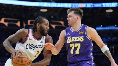 Los Angeles Lakers guard Luka Doncic (77) pressures Los Angeles Clippers forward Kawhi Leonard (2) during the second half of an NBA Cup basketball game Tuesday, Nov. 25, 2025, in Los Angeles. (AP Photo/Jae C. Hong)