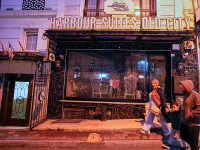 People walk past the Harbour Suites Old City hotel, in Istanbul, Turkey, Monday, Nov. 24, 2025. (AP Photo/Emrah Gurel)