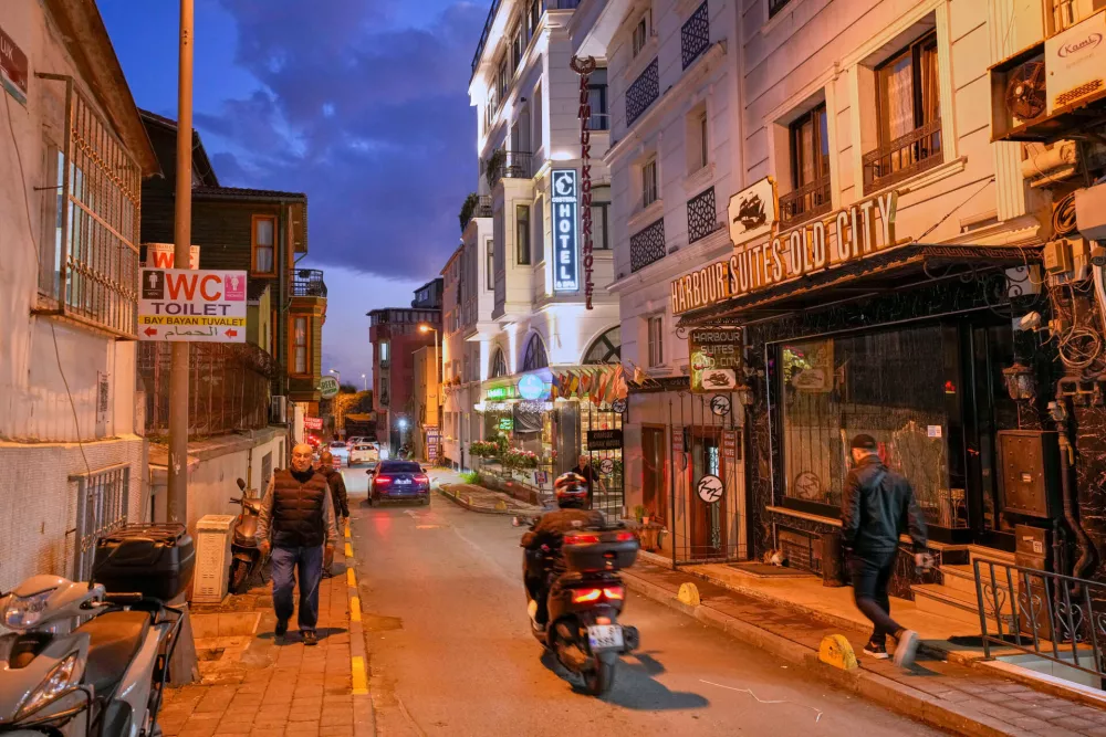 People walk past the Harbour Suites Old City hotel, in Istanbul, Turkey, Monday, Nov. 24, 2025. (AP Photo/Emrah Gurel)