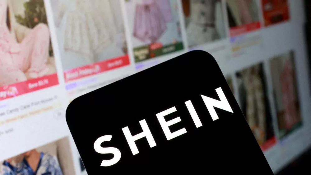 FILE PHOTO: Shein logo and their web page on smartphone in this illustration taken November 5, 2025. REUTERS/Dado Ruvic/Illustration/File Photo