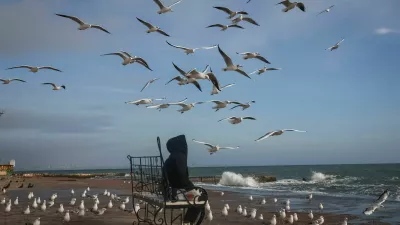 A woman sits at the beach, amid Russia's attack on Ukraine, in the Black Sea port of Odesa, Ukraine November 26, 2025. REUTERS/Nina Liashonok