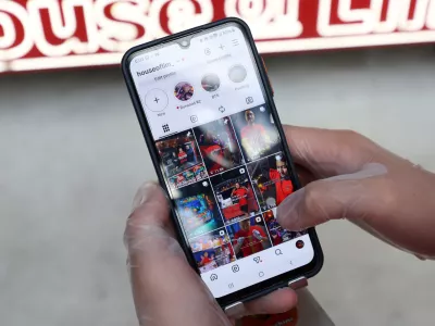 Dimi Heryxlim, 15, a social media content creator, poses while displaying his 'House of Lim' Instagram page at Burwood Chinatown in Sydney, Australia, November 14, 2025. REUTERS/Hollie Adams