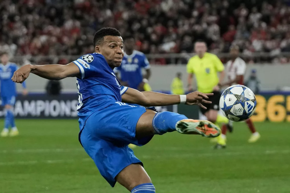 Real Madrid's Kylian Mbappe attempts a shot on goal during the Champions League opening phase soccer match between Olympiacos and Real Madrid in Piraeus port, near Athens, Greece, Wednesday, Nov. 26, 2025. (AP Photo/Thanassis Stavrakis)