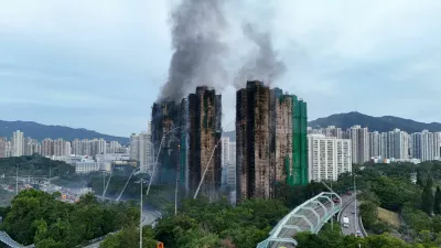 A drone view shows flames and thick smoke rising from the Wang Fuk Court housing estate during a major fire, in Tai Po, Hong Kong, China, November 27, 2025. REUTERS/Tyrone Siu   TPX IMAGES OF THE DAY