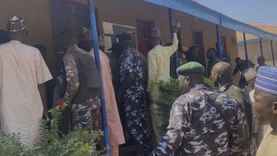 Police and government officials gather at St. Mary's Catholic Primary and Secondary School where gunmen on Friday abducted children and staff in Papiri community, Nigeria, Tuesday, Nov.25, 2025. (AP Photo/Yunusa Umar)