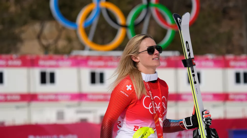 FILE -Lara Gut-Behrami, of Switzerland leaves after the medal ceremony after winning the gold medal in the women's super-G at the 2022 Winter Olympics, Feb. 11, 2022, in the Yanqing district of Beijing. (AP Photo/Luca Bruno, File)