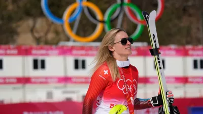 FILE -Lara Gut-Behrami, of Switzerland leaves after the medal ceremony after winning the gold medal in the women's super-G at the 2022 Winter Olympics, Feb. 11, 2022, in the Yanqing district of Beijing. (AP Photo/Luca Bruno, File)