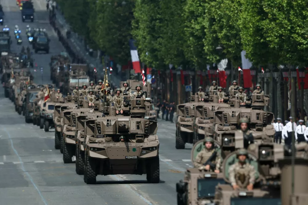 FILE PHOTO: Jaguar armoured vehicles of the 1st Spahis Regiment drive down the Champs-Elysees avenue during the annual Bastille Day military ceremony in Paris, France, July 14, 2025. REUTERS/Gonzalo Fuentes/File Photo