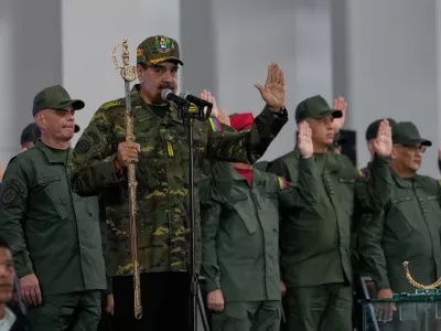 Venezuelan President Nicolas Maduro administers an oath during a civic-military event at the military academy in Caracas, Venezuela, Tuesday, Nov. 25, 2025. (AP Photo/Ariana Cubillos)