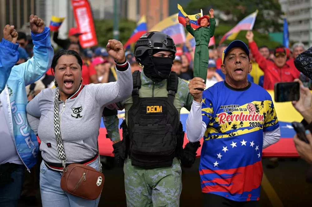 People take part in a rally against a possible escalation of U.S. actions toward the country, in Caracas, Venezuela, November 25, 2025. REUTERS/Gaby Oraa