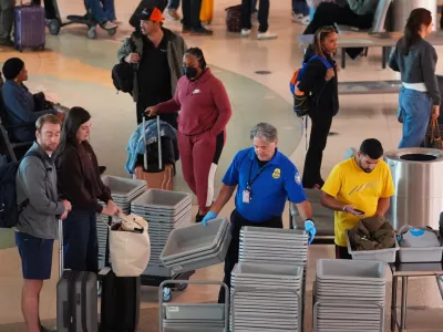 Travelers make their way through security at Love Field Airport, Wednesday, Nov. 26, 2025, in Dallas. (AP Photo/LM Otero)
