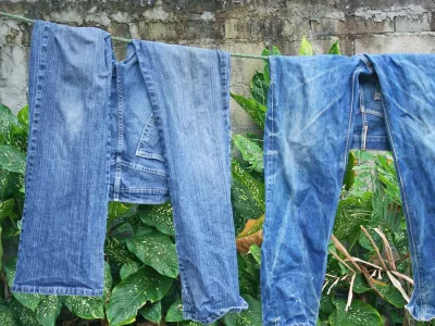 Two blue jeans pants on a clothes line