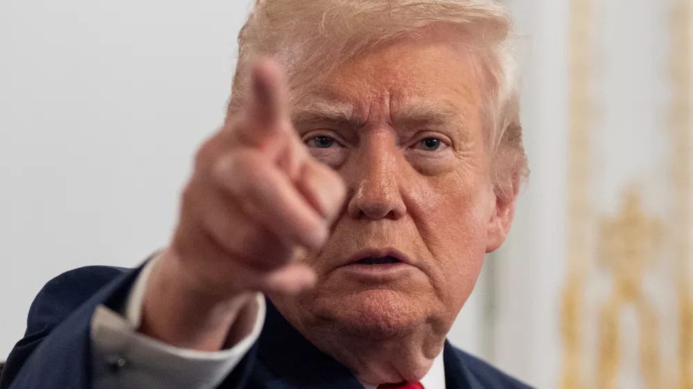 President Donald Trump speaks to reporters after speaking to troops via video from his Mar-a-Lago estate on Thanksgiving, Thursday, Nov. 27, 2025, in Palm Beach, Fla. (AP Photo/Alex Brandon)