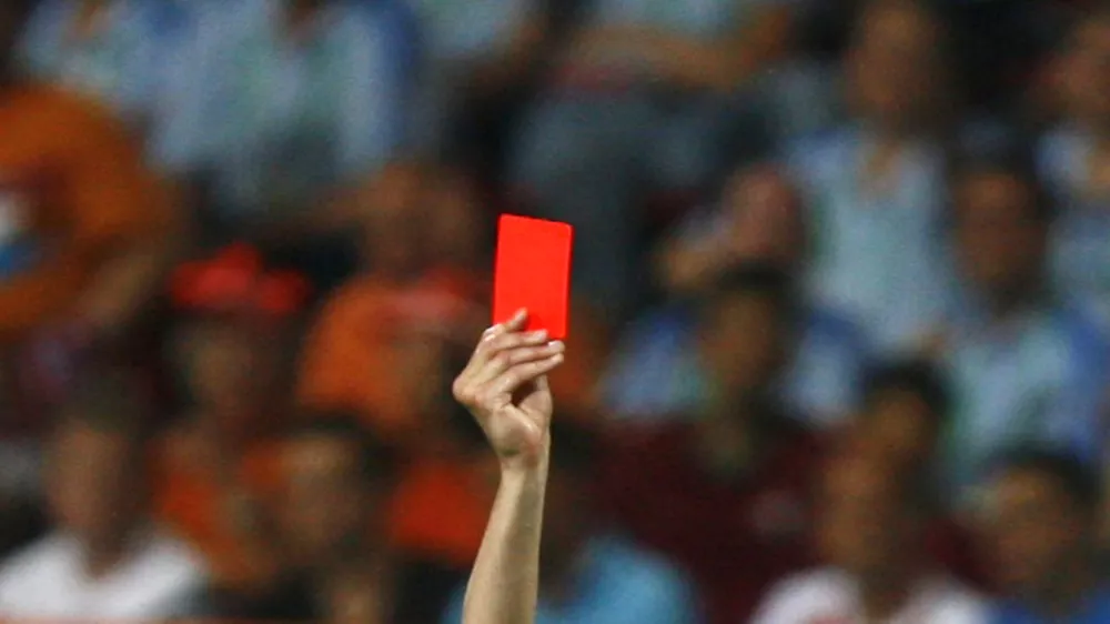 Referee Valentin Ivanov of Russia shows a red card during the second round World Cup 2006 soccer match between Portugal and the Netherlands in Nuremberg June 25, 2006. In a dramatic and explosive game marked by a flurry of yellow cards and four reds, a record for a match at any World Cup finals, Portugal clung on to Maniche Ribeiro's goal to win 1-0. FIFA RESTRICTION - NO MOBILE USE   REUTERS/Jerry Lampen (GERMANY)