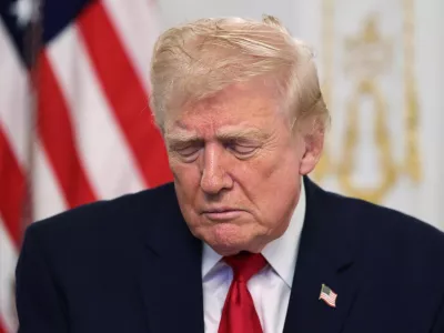 U.S. President Donald Trump looks down as he participates in a call with service members of U.S. Army, JTF-Southern Border, 101st Airborne Division (Fort Huachuca, AZ), U.S. Marine Corps, Battalion Landing Team 3d Battalion 6th Marines (Puerto Rico), U.S. Navy, IWO JIMA ARG, 22 MEU, (Underway, SOUTHCOM AOR), U.S. Air Force, 7th Bomb Wing (Dyess AFB, Abilene, TX), U.S. Space Force, 18th Space Defense Squadron (Vandenberg Space Force Base, CA), and U.S. Coast Guard, USCGC FORREST REDNOUR, WPC-1129 (Underway), on Thanksgiving, in Palm Beach, Florida, U.S., November 27, 2025. REUTERS/Anna Rose Layden