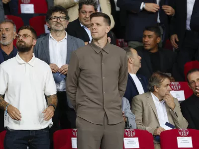 Wojciech Szczesny, centre, a new goalkeeper for Barcelona is on stands during the Champions League soccer match between Barcelona and Young Boys at the Lluis Companys Olympic Stadium in Barcelona, Spain, Tuesday, Oct. 1, 2024. (AP Photo/Joan Monfort)