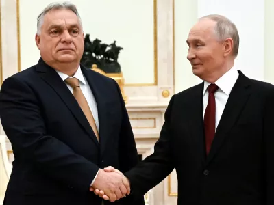 Russian President Vladimir Putin, right, and Hungarian Prime Minister Viktor Orban shake hands during their meeting at the Senate Palace of the Kremlin in Moscow, Russia, Friday, Nov. 28, 2025. (Alexander Nemenov/Pool Photo via AP)