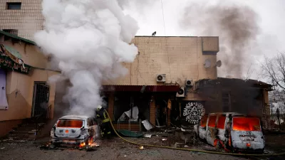 A firefighter extinguishes a fire in a car damaged during a Russian missile and drone attack on Kyiv, amid Russia's attack on Ukraine, November 29, 2025. REUTERS/Valentyn Ogirenko