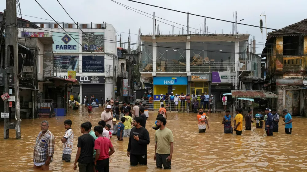 People gather at an area affected by floods, following heavy rainfall in Malwana, Sri Lanka, November 29, 2025. REUTERS/ Thilina Kaluthotage