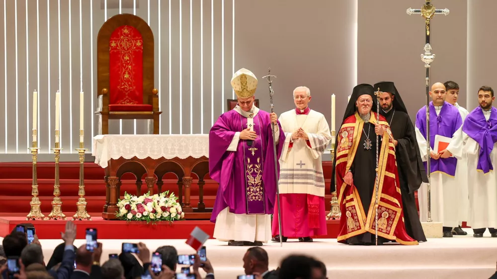 Pope Leo XIV walks with Ecumenical Patriarch Bartholomew I after presiding over the Holy Mass at the Volkswagen Arena, during his first apostolic journey, in Istanbul, Turkey, November 29, 2025. REUTERS/Umit Bektas