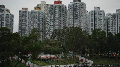 People queue to place flowers at a makeshift memorial near Wang Fuk Court housing estate to pay tribute to victims of the deadly fire at the Wang Fuk Court housing complex, in Tai Po, Hong Kong, China, November 30, 2025. REUTERS/Lam Yik
