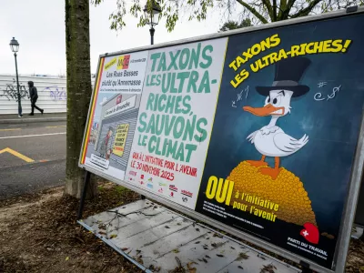 A person walks by referendum posters of political parties and associations as Swiss voters are casting ballots to decide whether women, like men, must do national service in the military, civil protection teams or in other forms, in Geneva, Switzerland, on Nov. 26, 2025. (Martial Trezzini/Keystone via AP)
