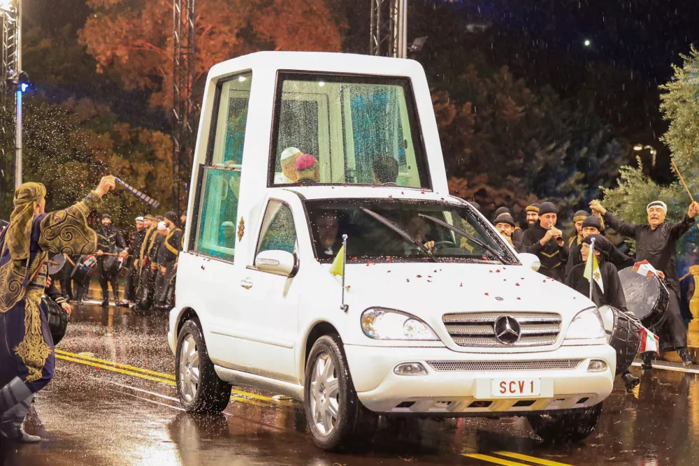 Artists perform the Dabke, a traditional Levantine dance, as Pope Leo XIV travels in the popemobile as he arrives at the Presidential Palace, during his first apostolic journey, in Baabda, Lebanon, November 30, 2025. REUTERS/Mohamed Azakir