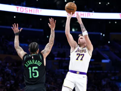 Los Angeles Lakers guard Luka Doncic (77) shoots against New Orleans Pelicans guard Jose Alvarado (15) during the second half of an NBA basketball game, Sunday, Nov. 30, 2025, in Los Angeles. (AP Photo/Jessie Alcheh)