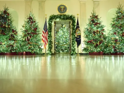 Christmas trees decorate the Cross Hall of the White House during a press preview of the Christmas decorations "Home is Where the Heart Is," Monday, Dec. 1, 2025, in Washington. (AP Photo/Evan Vucci)