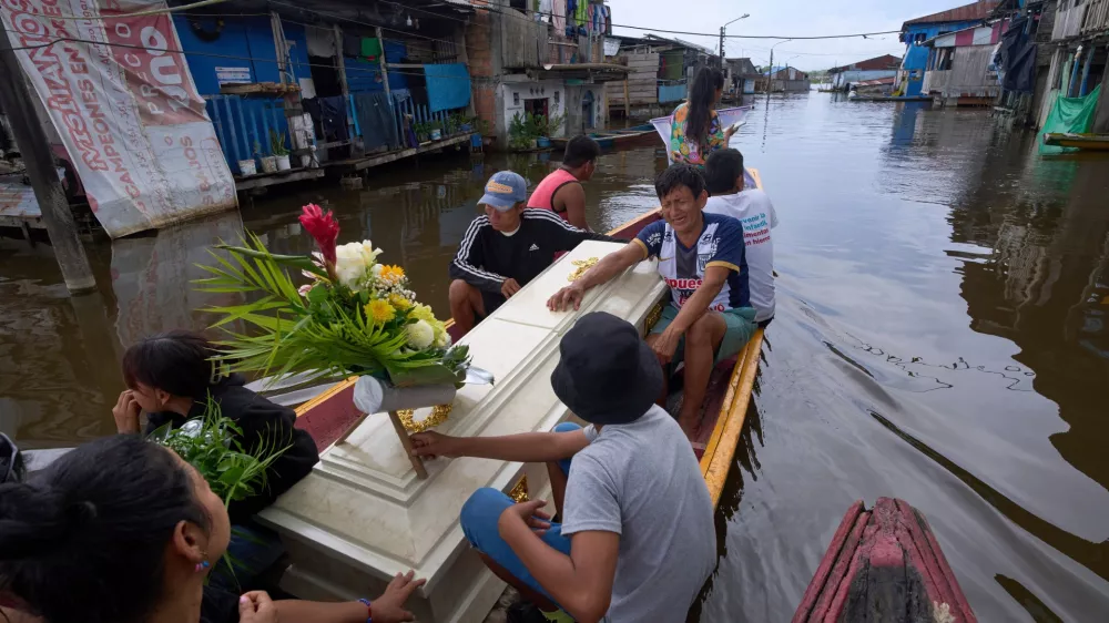 Friends and relatives of Jorge Luis Mendoza Cuelho, 14, ride with his coffin during his funeral in Belen, a district nicknamed the "Venice of the Jungle," in Iquitos, Peru, on May 23, 2025. (AP Photo/Rodrigo Abd, File)