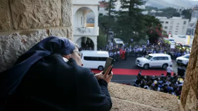 A nun takes a picture on the day Pope Leo XIV visits the De La Croix Psychiatric Hospital, during his first apostolic journey, in Jal el-Dib, Lebanon December 2, 2025. REUTERS/Louisa Gouliamaki