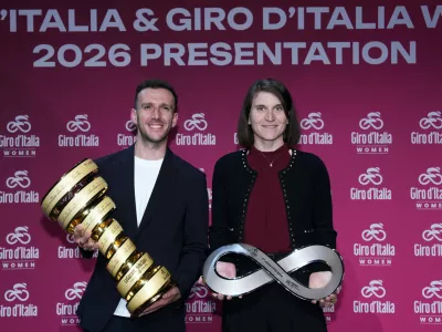 Elisa Longo Borghini and Simon Yateshold trophies during the presentation of the 2026 Giro d'Italia man and women in Rome, Italy, Dec. 1, 2025. (Massimo Paolone/LaPresse via AP)