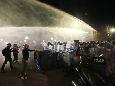 Police use a water cannon to block protesters during an opposition rally in the city center of Tbilisi, Georgia, on Saturday, Oct. 4, 2025, boycotting the municipal elections and call for the release of political opponents. (AP Photo/Zurab Tsertsvadze)
