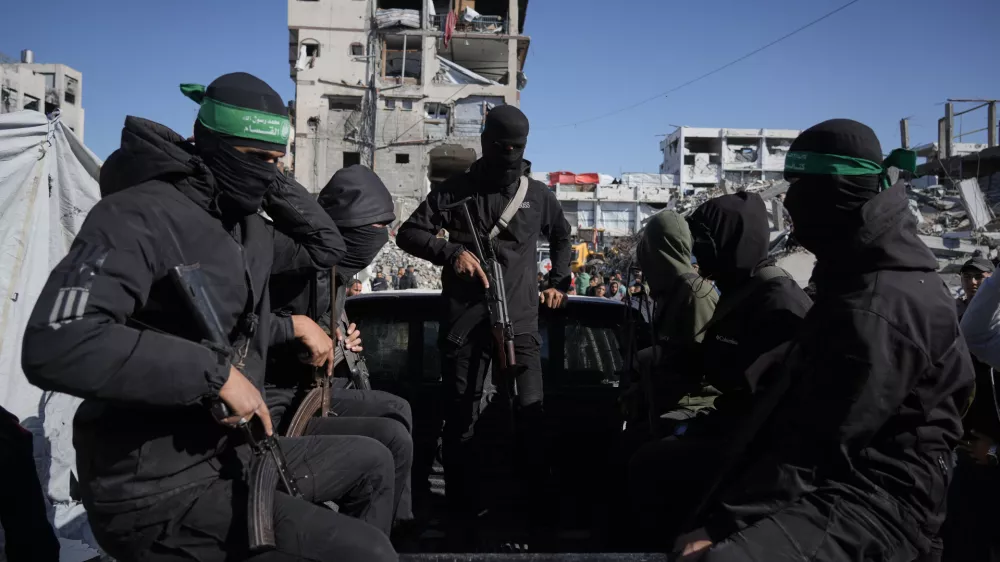 Hamas militants arrive at a site where they are searching for the remains of hostages in Jabalia, northern Gaza Strip, Monday, Dec. 1, 2025. (AP Photo/Jehad Alshrafi)