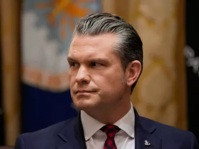 Defense Secretary Pete Hegseth listens as President Donald Trump speaks during a Cabinet meeting at the White House, Tuesday, Dec. 2, 2025, in Washington. (AP Photo/Julia Demaree Nikhinson)