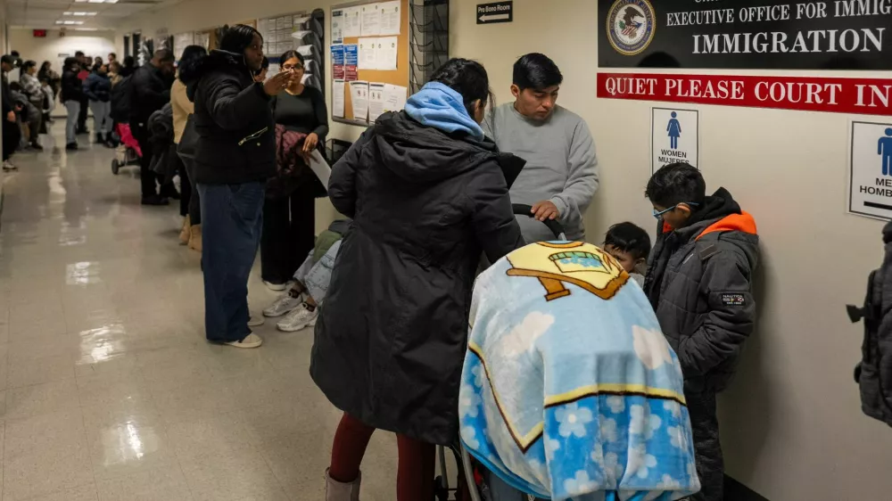 Respondents wait to enter their hearings at the U.S. Immigration Court in Manhattan, in New York City, U.S., December 2, 2025. REUTERS/David 'Dee' Delgado