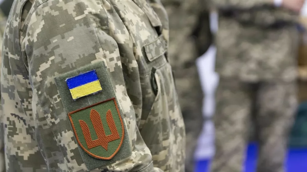 Ukrainian flag and coat of arms on the chevron of a Ukrainian soldier,Image: 993036599, License: Royalty-free, Restrictions:, Model Release: yes