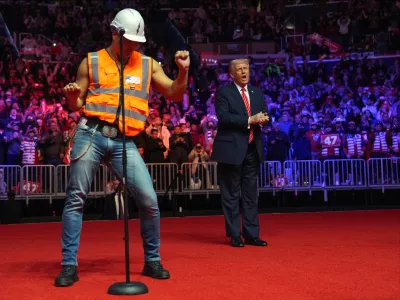 President-elect Donald Trump dances with The Village People at a rally ahead of the 60th Presidential Inauguration, Jan. 19, 2025, in Washington. (AP Photo/Evan Vucci, File)
