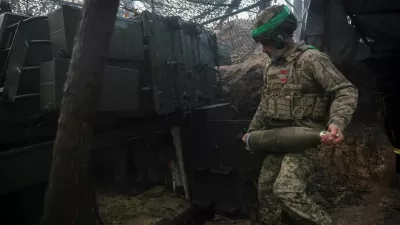 A serviceman of the 38th Separate Marine Brigade of the Ukrainian Armed Forces carries a shell for a M109A5 self-propelled howitzer as he prepares to fire towards Russian troops at a position in a front line, amid Russia's attack on Ukraine, near the frontline town of Pokrovsk in Donetsk region, Ukraine November 21, 2025. REUTERS/Anatolii Stepanov