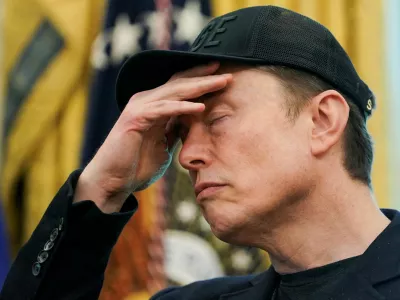 FILE PHOTO: Elon Musk reacts during a press conference with U.S. President Donald Trump (not pictured), at the White House in Washington, D.C., U.S., May 30, 2025. REUTERS/Nathan Howard/File Photo