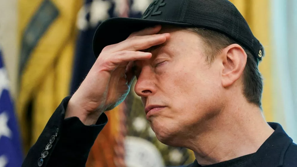 FILE PHOTO: Elon Musk reacts during a press conference with U.S. President Donald Trump (not pictured), at the White House in Washington, D.C., U.S., May 30, 2025. REUTERS/Nathan Howard/File Photo
