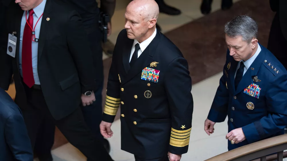 U.S. Navy Adm. Frank "Mitch" Bradley, center, commander of the U.S. Special Operations Command, and Gen. Dan Caine, chairman of the Joint Chiefs of Staff, right, are escorted to a classified briefing for top congressional lawmakers overseeing national security as they investigate how Defense Secretary Pete Hegseth handled a military strike on a suspected drug smuggling boat and its crew in the Caribbean near Venezuela Sept. 2, at the Capitol in Washington, Thursday, Dec. 4, 2025. (AP Photo/J. Scott Applewhite)