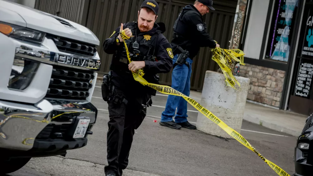 Investigators with the San Joaquin Sheriff's Department remove crime scene tape at Thornton Blvd. and Lucile Ave., where a mass shooting took place Saturday in a banquet hall in Stockton, Calif., Sunday, Nov. 30, 2025. (Brontë Wittpenn/San Francisco Chronicle via AP)